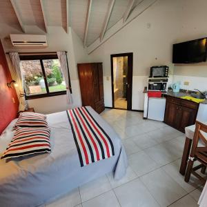 a bedroom with a bed and a kitchen at Merlo Trail Lodge in Merlo