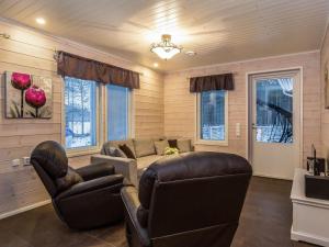 a living room with a couch and two chairs at Holiday Home Kalaranta by Interhome in Lihavanpää