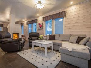 a living room with a couch and chairs and a table at Holiday Home Kalaranta by Interhome in Lihavanpää +15 photos