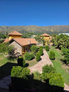 a garden with a house and some bushes and trees at Merlo Trail Lodge in Merlo