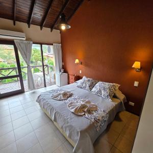 a bedroom with a bed with towels on it at Merlo Trail Lodge in Merlo +64 photos