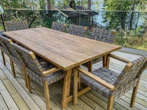 a wooden table and chairs on a deck at Holiday Home Klippan by Interhome in Tuuhonen