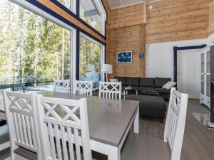 a dining room and living room with a table and chairs at Holiday Home Klippan by Interhome in Tuuhonen