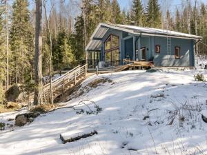 a tiny house in the woods in the snow at Holiday Home Klippan by Interhome in Tuuhonen