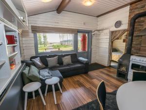 a living room with a couch and a table at Holiday Home Jarsala by Interhome in Töfsala