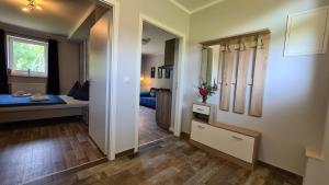 a room with a bedroom and a bed and a hallway at 08 Heuwiese - Hof Wiesengrund in Parchtitz +26 photos