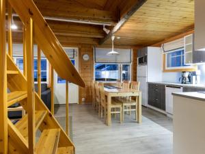 a kitchen and dining room with a table and chairs at Holiday Home Albatrossi by Interhome in Levi