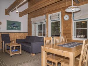 a living room with a table and a couch at Holiday Home Albatrossi by Interhome in Levi
