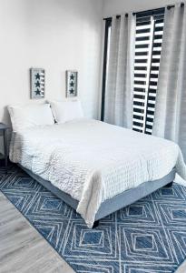 a bedroom with a large bed with a blue rug at Stylish Studio Apt-Outside NYC in West New York