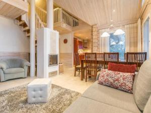 a living room with a couch and a dining room at Holiday Home Akavilla 2 by Interhome in Jämsä