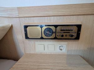 a room with a bed with a control panel at Serviced Rooms ''Krone'' in Creglingen