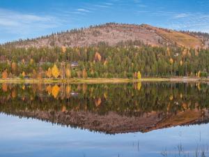 a reflection of a mountain in a lake at Holiday Home Sallanhelmi e2 by Interhome in Salla