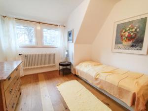 a bedroom with a bed and a painting on the wall at Ferienhaus Iris in Radolfzell am Bodensee
