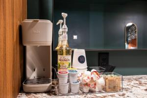 a bottle of champagne sitting on a counter next to a coffee maker at Hollyhock Suite 404 in Louisville