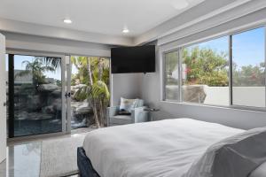 a bedroom with a bed and a large window at Encinitas Shores - Beachfront, Ocean View & Patio in Encinitas +97 photos
