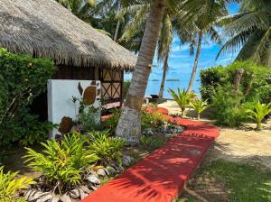 a resort with a red pathway leading to a building at Fare PEA ITI Romantic Lodge in Patio +19 photos