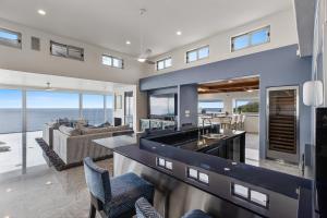 a kitchen and living room with a view of the ocean at Encinitas Shores - Beachfront, Ocean View & Patio in Encinitas
