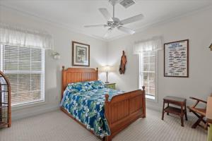 a bedroom with a bed and a ceiling fan at River Watcher Cottage in Bell