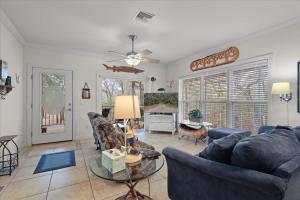 a living room with couches and a table at River Watcher Cottage in Bell