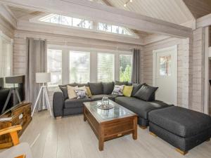 a living room with a couch and a coffee table at Holiday Home Villa valo by Interhome in Kolinkylä