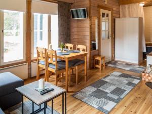 a kitchen and living room with a table and chairs at Holiday Home Yllästokka 5 by Interhome in Ylläsjärvi