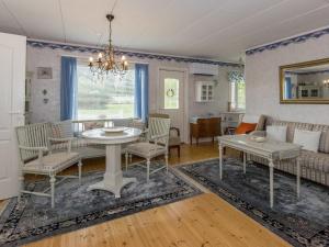 a dining room and living room with a table and chairs at Holiday Home Salmiranta by Interhome in Jämijärvi +10 photos