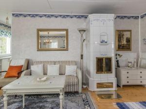 a living room with a couch and a table at Holiday Home Salmiranta by Interhome in Jämijärvi