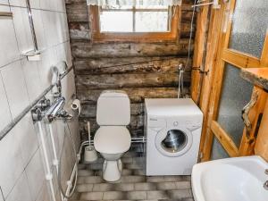 a small bathroom with a toilet and a sink at Holiday Home Kelokota by Interhome in Salla +14 photos