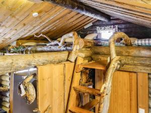 a log cabin with a table and a chair in it at Holiday Home Kelokota by Interhome in Salla