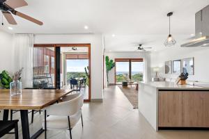 a kitchen and living room with a table and a dining room at Panaromic Oceanview Luxury 3BR Private Rooftop in Tamarindo