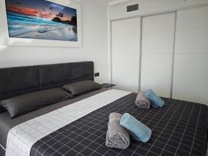 a bedroom with a bed with two pillows on it at Sea&Skyline Suites Benidorm in Benidorm +29 photos