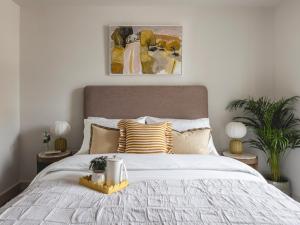 a bedroom with a large white bed with pillows at Charles Hope Cambridge in Cambridge