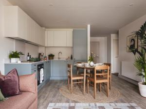 a kitchen and living room with a table and chairs at Charles Hope Cambridge in Cambridge