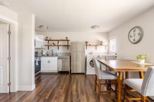 a kitchen and dining room with a table and a clock at 721 Cozy Mid-Town Hideaway in Reno