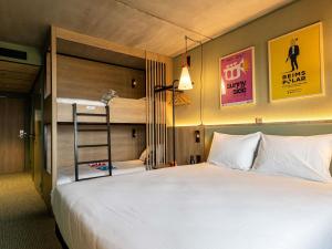 a bedroom with two bunk beds and a ladder at greet Hotel Reims Tinqueux in Reims