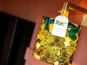 a bag with a price tag hanging on a door at greet Hotel Reims Tinqueux in Reims