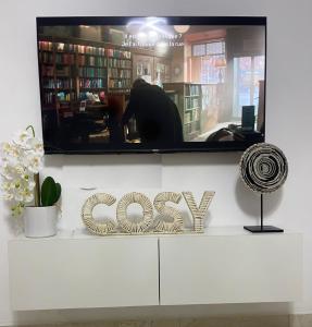 a tv sitting on top of a shelf in a library at Bark luxury apartments Abidjan Attoban 2 in Abidjan