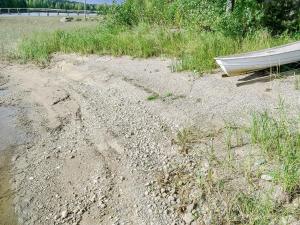 a boat sitting on the sand next to a body of water at Holiday Home Haapalehto by Interhome in Nurmes +16 photos