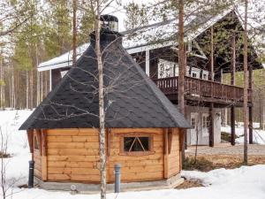 a small log cabin with a black roof at Holiday Home Lux iii by Interhome in Salla +25 photos