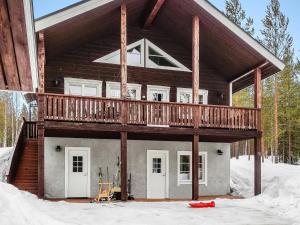 a house with a balcony on top of it in the snow at Holiday Home Lux iii by Interhome in Salla