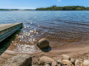 a dock on a lake with rocks in the water at Holiday Home Rantalinna 2 by Interhome in Ruokolahti +17 photos