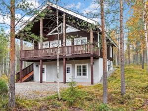 a house with a deck in the woods at Holiday Home Lux iii by Interhome in Salla