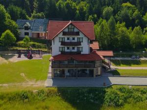an aerial view of a large house with a red roof at Pensiunea BriAdda in Poiana Mărului