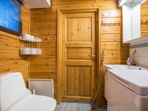 a bathroom with a toilet and a sink at Holiday Home Lehtotuvat e by Interhome in Kotila +11 photos