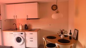 a kitchen with a table and a washing machine at Casa Cristina - Rioja II in Cenicero +7 photos