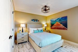 a bedroom with a bed and a painting on the wall at Updated 3BR w/ Gulf Views: Suntide III - Unit 801 in South Padre Island +47 photos