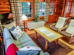 a living room with a couch and a table at Holiday Home Luppokero by Interhome in Salla