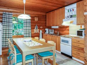 a kitchen with a table and chairs in a room at Holiday Home Luppokero by Interhome in Salla