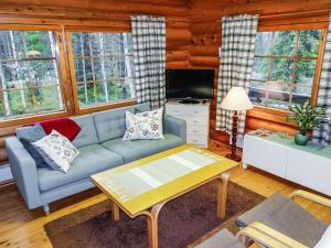 a living room with a couch and a table at Holiday Home Luppokero by Interhome in Salla +19 photos