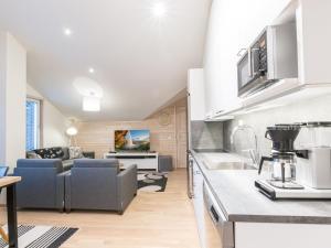 a kitchen and living room with a couch at Holiday Home Levin stara a09 by Interhome in Levi